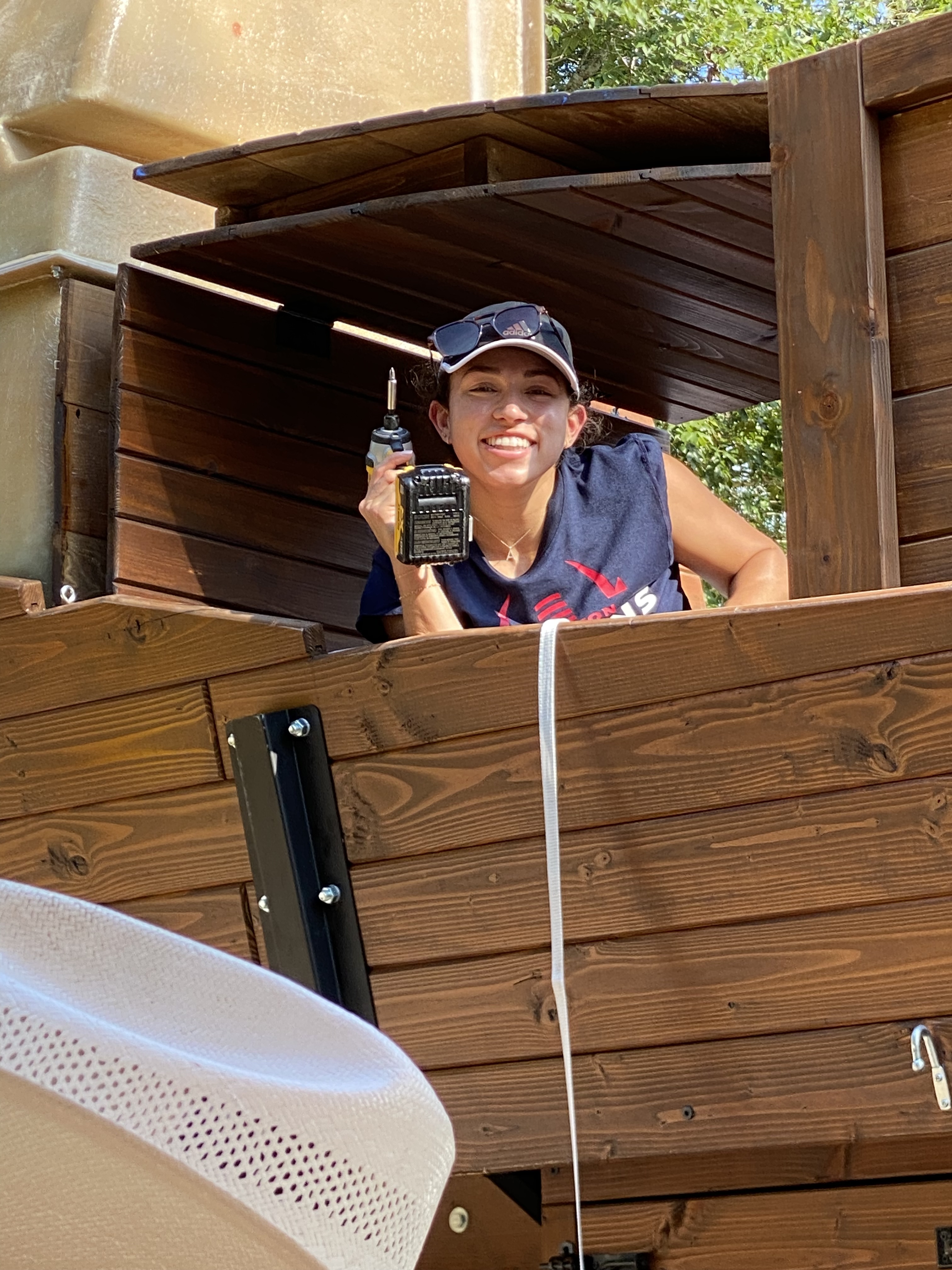 Tay helping work on a covered wagon at Blue Pond Retreat
